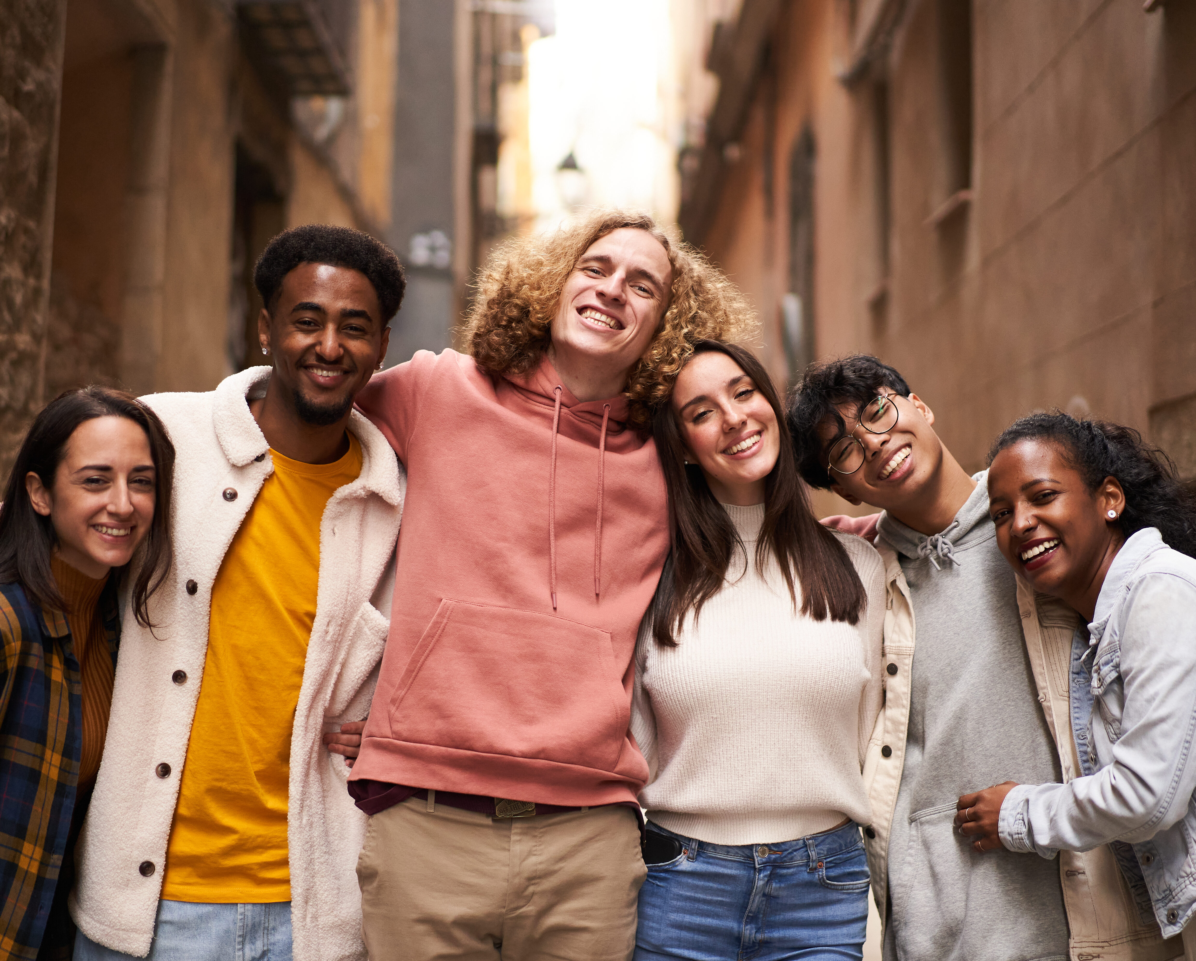 Portrait of a group of happy young students looking at the camera smiling.